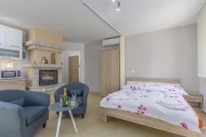 a bedroom with a bed and a living room at Villa Filo Apartments in Umag