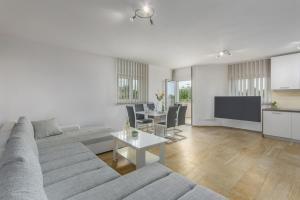 a living room with a couch and a table at Villa Filo Apartments in Umag