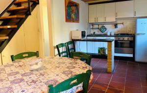 a kitchen with a table and chairs and a kitchen with a refrigerator at Dante Appartamento con giardino in Levanto +5 photos