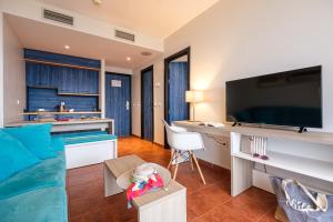 a living room with a large flat screen tv at Estival Islantilla in Islantilla