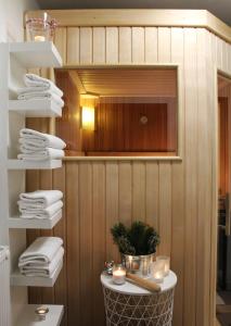 a room with wooden walls and a shelf with towels at Landhof Kreuzsalgut in Wagrain