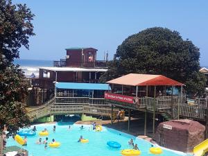 a group of people in a pool at a water park at Barefoot Bungalo in Amanzimtoti