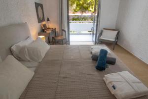 a large bed with towels on it in a room at Apollo Resort in Agia Marina Aegina