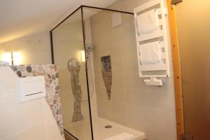 a shower with a glass door in a bathroom at Zum Eichhof Zimmer 12 in Reit im Winkl