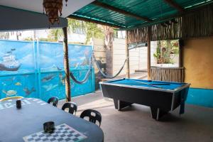 a ping pong room with a pool table and a mural at Big Blue Backpackers in Cape Town