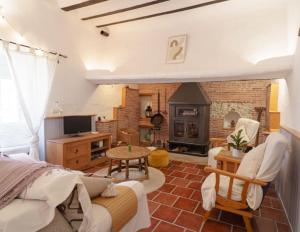 a living room with a couch and a fireplace at Casa rural con jacuzzi y chimenea en paraje único - La Casa del Pino in Blanca
