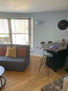 a living room with a couch and a table at The Thisle in Bristol