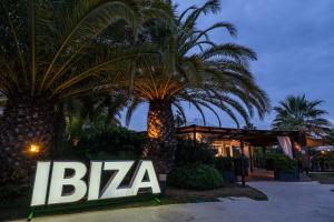 a sign that says bza in front of two palm trees at Estival Islantilla in Islantilla