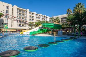 a large pool with a water slide in a city at Estival Islantilla in Islantilla