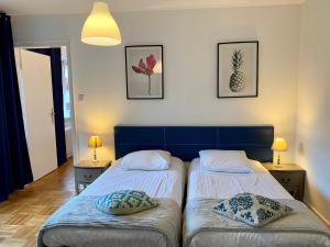 a bedroom with two beds with pillows on them at Appartement Gare Strasbourg Parking in Strasbourg