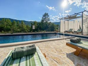a swimming pool with a bench and a table at Villa Vinka in Kozica