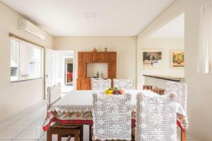 a dining room with a table and chairs at Casa na Praia da Vila in Imbituba