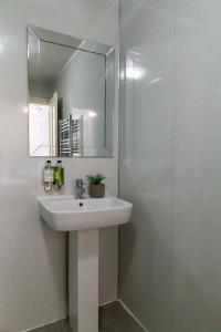 a bathroom with a sink and a mirror at Goodramgate Apartments in York