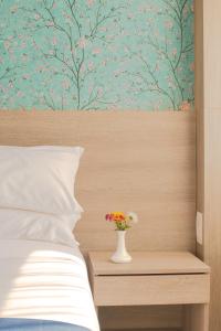 Letto o letti in una camera di Mila Hotel
