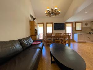 a living room with a couch and a dining room at Appartement Tignes, 4 pièces, 6 personnes - FR-1-480-2 in Tignes