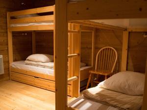 a bedroom with two bunk beds and a chair at Appartement Tignes, 3 pièces, 6 personnes - FR-1-480-22 in Tignes