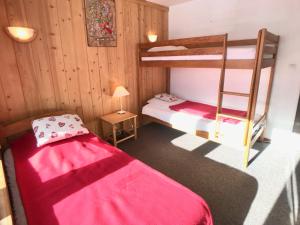 a bedroom with two bunk beds and a ladder at Appartement Tignes, 2 pièces, 5 personnes - FR-1-480-46 in Tignes