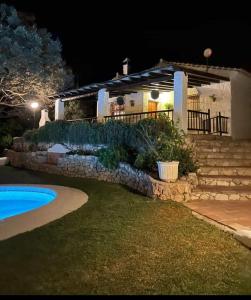 una casa por la noche con piscina en El Chorro Villas Casa Adelfa, en El Chorro