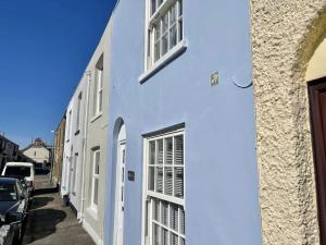 a white building with windows on a street at The Deal Retreat in Kent