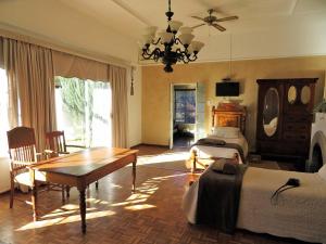 a bedroom with a table and a bed and a dining room at New Holme Nature Lodge in Hanover Road