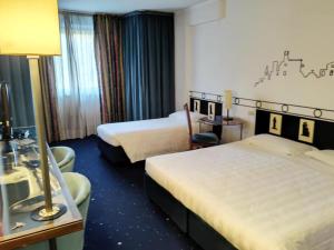 Кровать или кровати в номере Hotel Giò Wine e Jazz Area