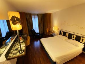 Кровать или кровати в номере Hotel Giò Wine e Jazz Area