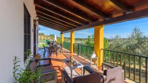 a patio with chairs and tables on a balcony at Colladopino La Puebla de Los Infantes by Ruralidays in La Puebla de los Infantes
