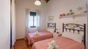 a bedroom with two beds and a window at Colladopino La Puebla de Los Infantes by Ruralidays in La Puebla de los Infantes +21 photos