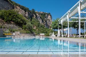 a swimming pool with a mountain in the background at Le Ancore Hotel in Vico Equense