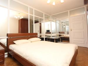 a bedroom with a bed and a room with a desk at Apartlux Vernadskogo Superior in Moscow