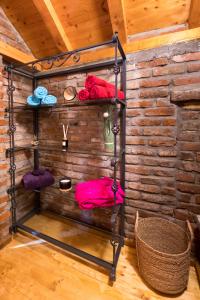 a towel rack in a room with a brick wall at River Side in Aljmaš