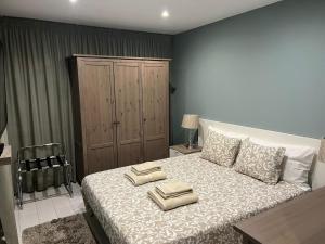 a bedroom with a bed with two towels on it at T3 Vilamoura in Vilamoura
