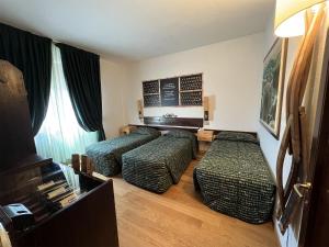 Кровать или кровати в номере Hotel Giò Wine e Jazz Area