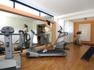 a woman on a treadmill in a gym at Hotel Giò Wine e Jazz Area in Perugia