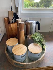 a group of bowls on a wooden tray on a counter at The Residence - Yarra Valley in Wandin North