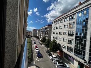 a view from a window of a city street with parked cars at GIRALDA 2 in Ponteareas