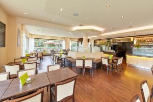 a restaurant with tables and chairs and a bar at Hotel Café Ernst in Bernkastel-Kues