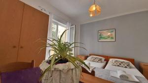 Postel nebo postele na pokoji v ubytování Apartments Mandalinic