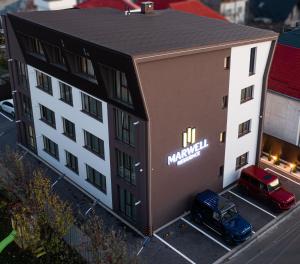 a model of a building with a car parked outside at Deluxe Aparthotel MARWELL RESIDENCE in Suceava