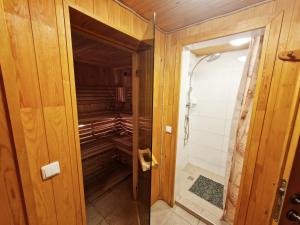 a walk in closet in a home with wooden walls at KALIDA B&B Rooms for rent in Raseiniai