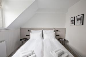 dwa białe łóżka w pokoju z dwoma ręcznikami w obiekcie Port Sołacz w Poznaniu