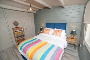 a bedroom with a bed with a colorful striped blanket at Springfort Hall Hotel in Mallow