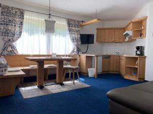 a living room with a table and a kitchen at Alt Poschach in Obergurgl