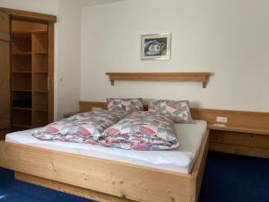 a bedroom with a bed with a wooden frame at Alt Poschach in Obergurgl