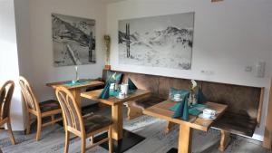 a dining room with two tables and two chairs at Alta Montagna in Mathon