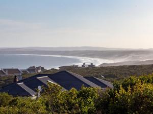 a row of solar panels on a hill with the ocean at Erika27 B&B NO LOADSHEDDING in Dana Bay