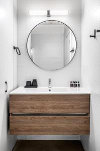 a bathroom with a sink and a mirror at HAYARKON - Superior Collection - By HOMY in Tel Aviv