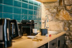 a kitchen counter with a coffee maker and a sink at Cohort Koukaki in Athens