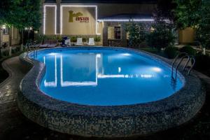 a swimming pool at night in a hotel at Hotel Asia Samarkand in Khodzha-Akhrar