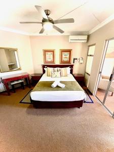 una camera con letto e ventilatore a soffitto di Perna Perna Lodge St Lucia a St Lucia